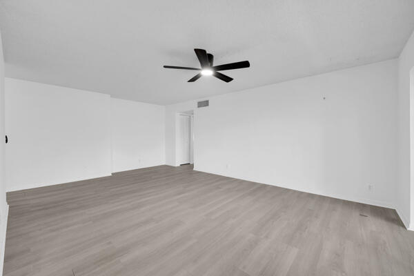 150 Pineview Road, Unit J6 Jupiter, FL 33469 - Photo 6 of 27 wooden floor in an empty room