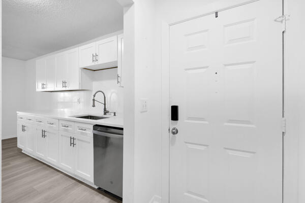 150 Pineview Road, Unit J6 Jupiter, FL 33469 - Photo 7 of 27 a kitchen with white cabinets and white appliances