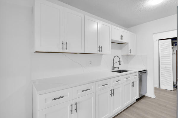 150 Pineview Road, Unit J6 Jupiter, FL 33469 - Photo 10 of 27 a kitchen with white cabinets