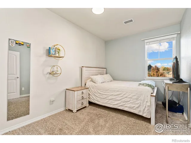 a bedroom with a bed and a cabinets