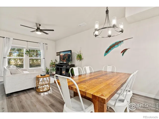 a living room with furniture wooden floor and chandelier