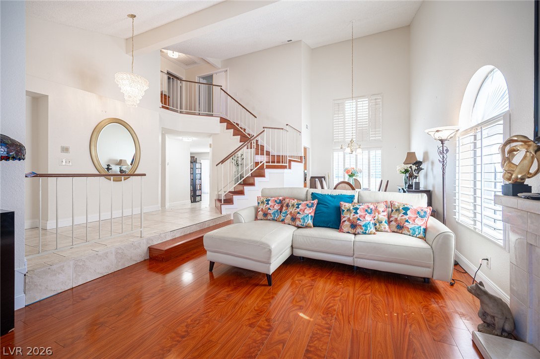 718 Rusty Spur Drive Henderson, NV 89014 - Photo 7 of 50 Elegant hardwood flooring throughout the living space complements the tall ceilings and inviting staircase.