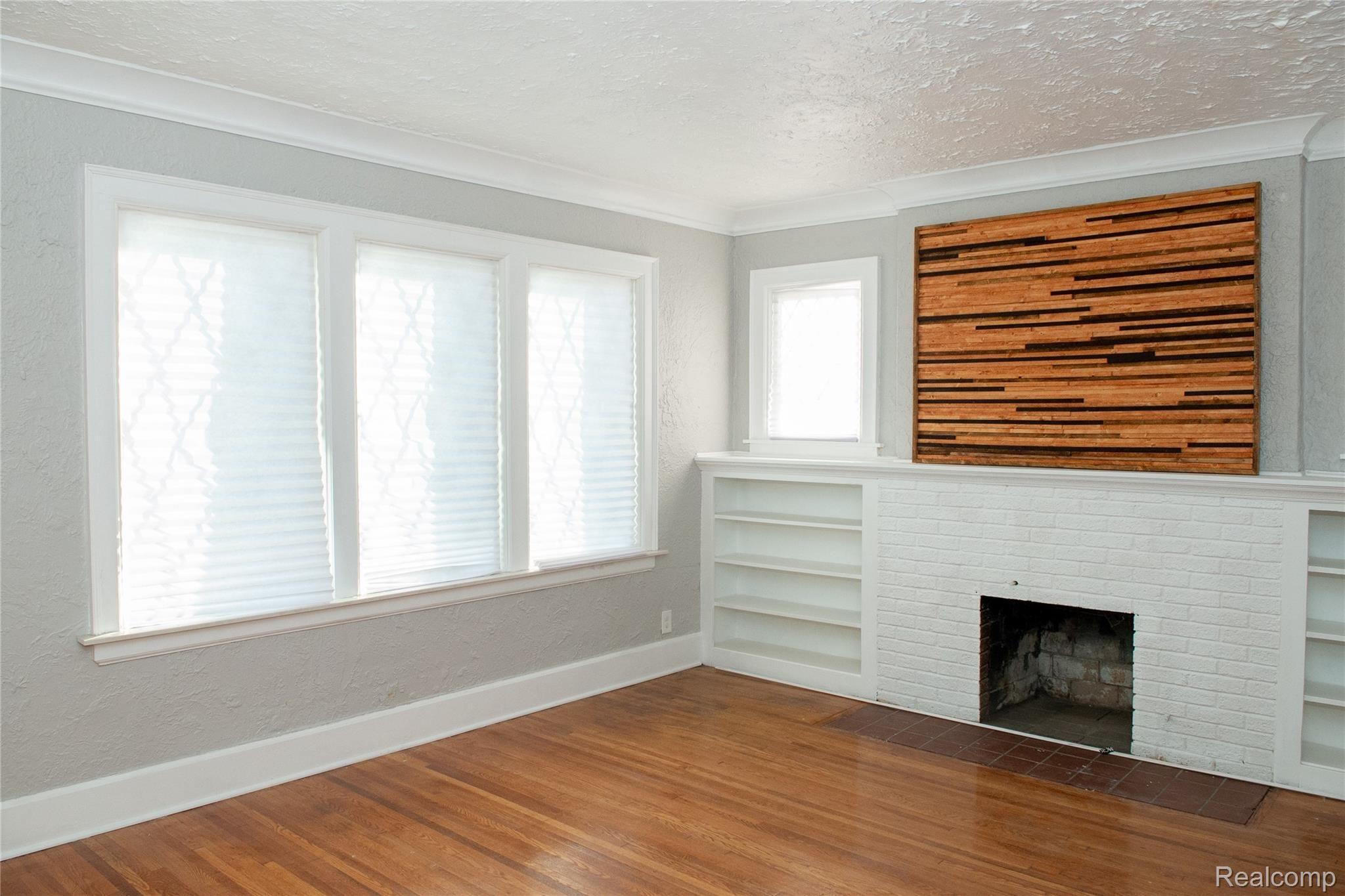 14585 Ashton Road Detroit, MI 48223 - Photo 9 of 29 Living room with natural fireplace