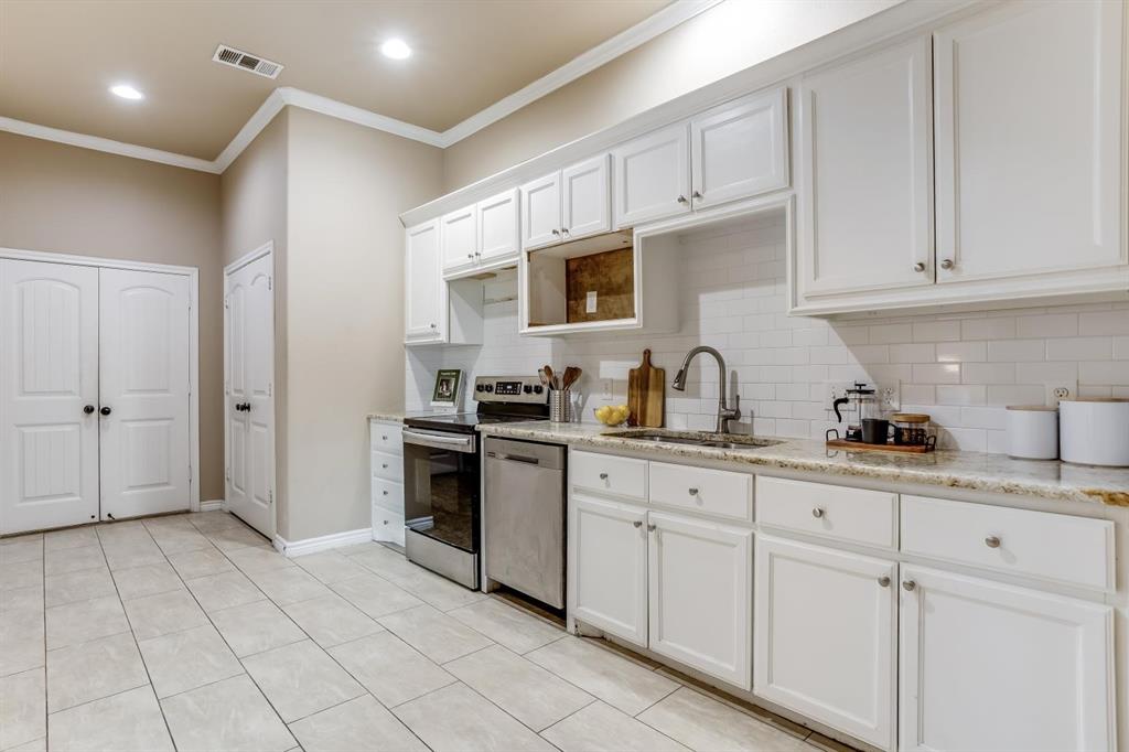 12364 Halima Street Dallas, TX 75243 - Photo 12 of 30 White shaker-style cabinetry, subway tile backsplash, stainless steel appliances, speckled stone countertops, and tile flooring