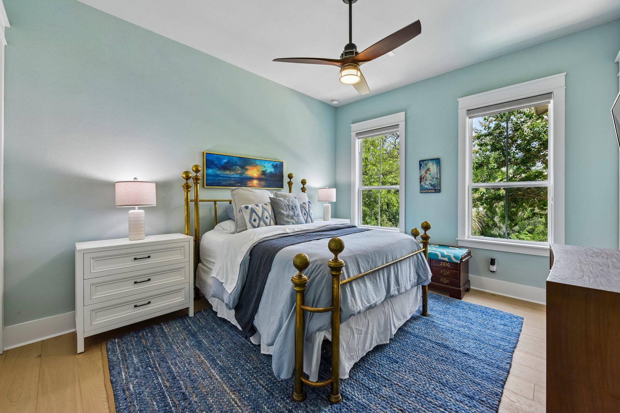 2203 Improver Road Spicewood, TX 78669 - Photo 17 of 38 Natural light floods this charming room, featuring light hardwood floors and a striking blue rug.