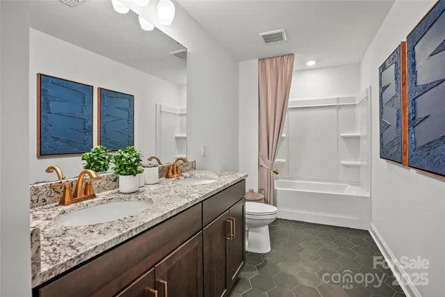 a bathroom with a granite countertop sink a toilet and bathtub
