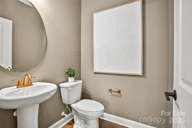 a bathroom with a sink mirror and toilet