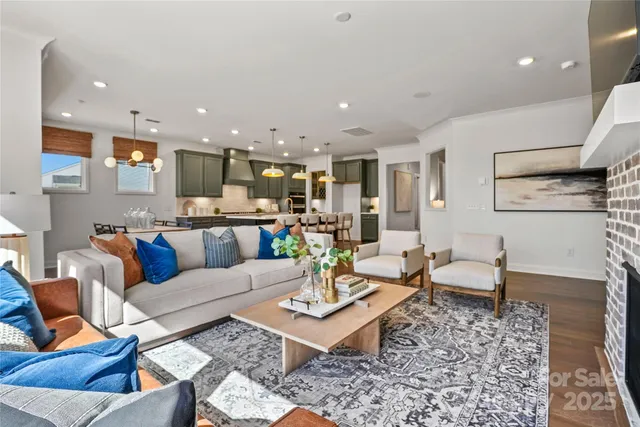 a living room with furniture and kitchen view