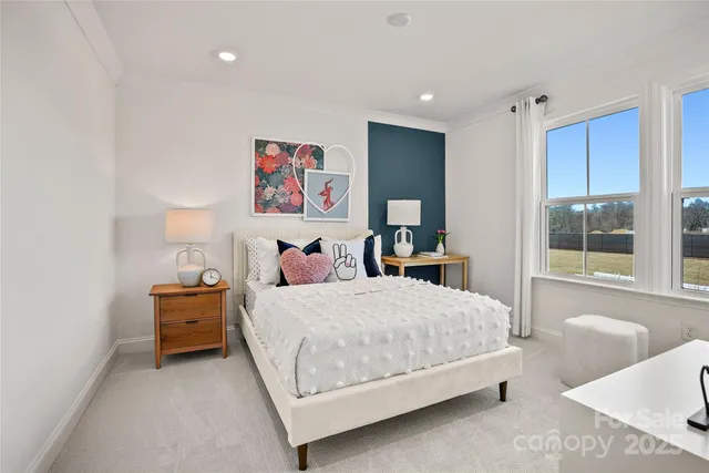 a bedroom with a bed and window