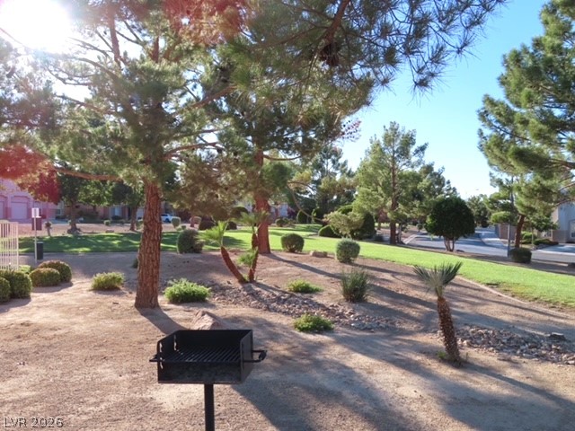 1623 Cave Spring Drive Henderson, NV 89014 - Photo 6 of 16 A community picnic area offers mature landscaping, green spaces, and a built-in barbecue for outdoor enjoyment.