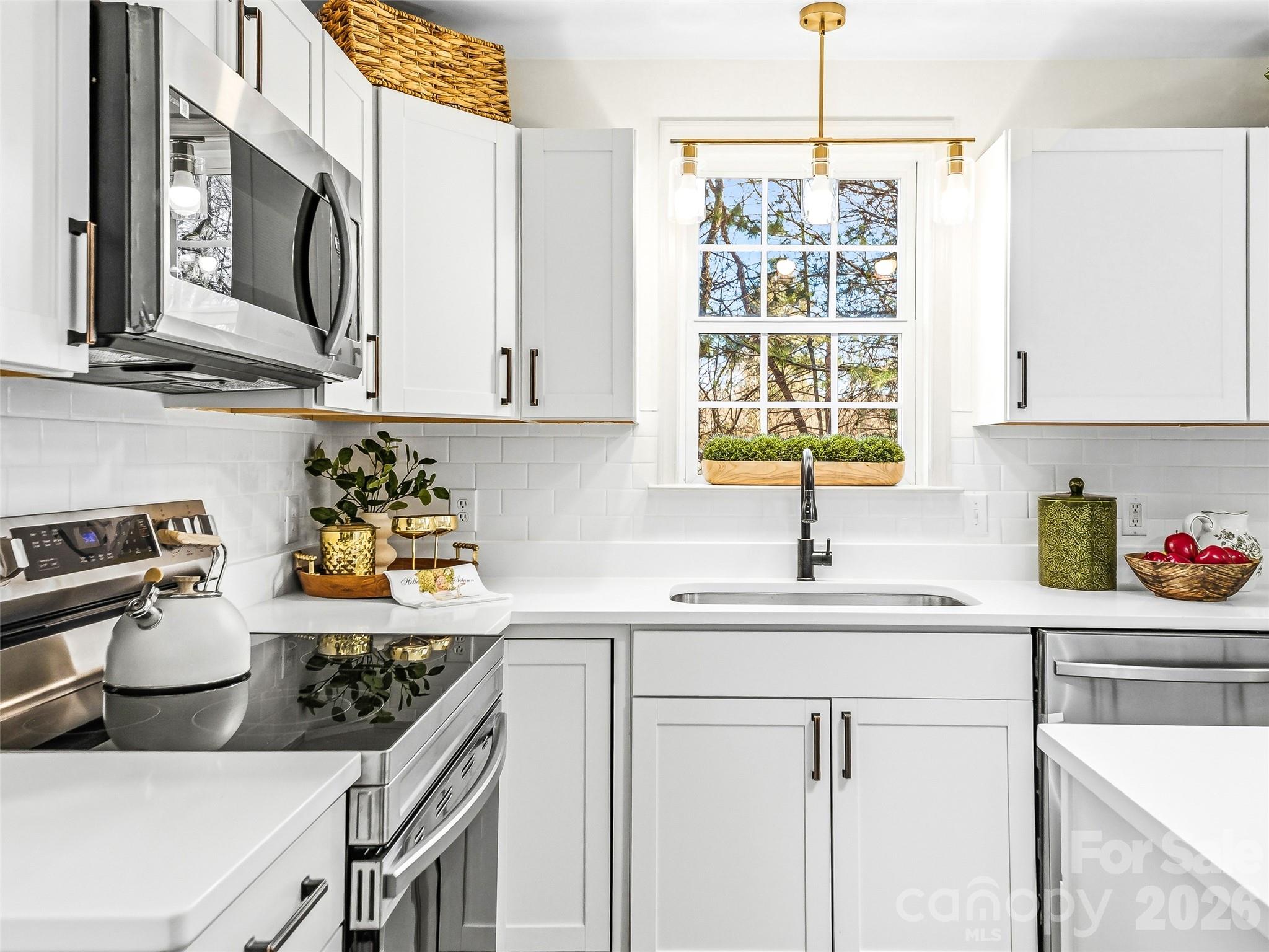 907 Gleason Street Arden, NC 28704 - Photo 21 of 41 a kitchen with a sink cabinets and window