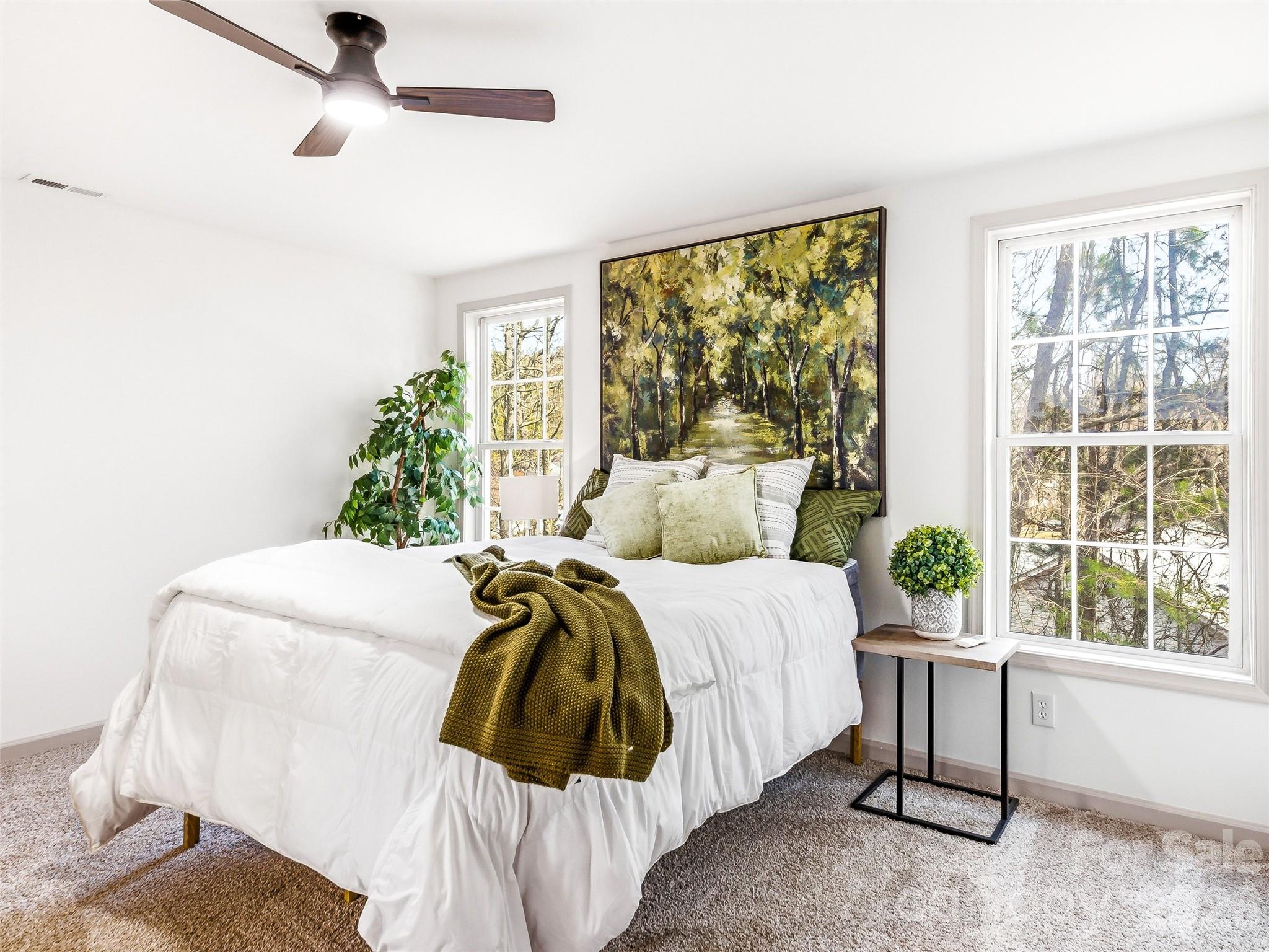 907 Gleason Street Arden, NC 28704 - Photo 22 of 41 a bed sitting in a bedroom next to a window