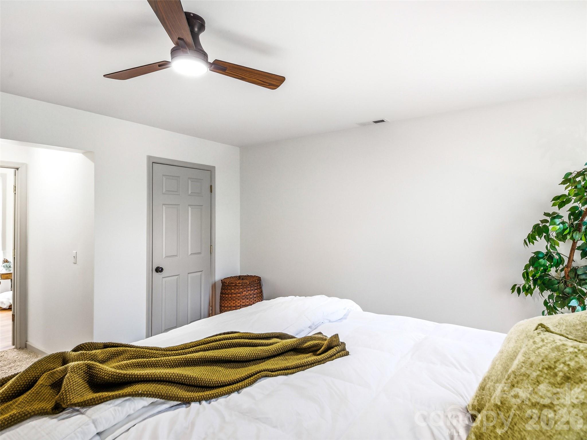 907 Gleason Street Arden, NC 28704 - Photo 24 of 41 a bedroom with a bed and a potted plant