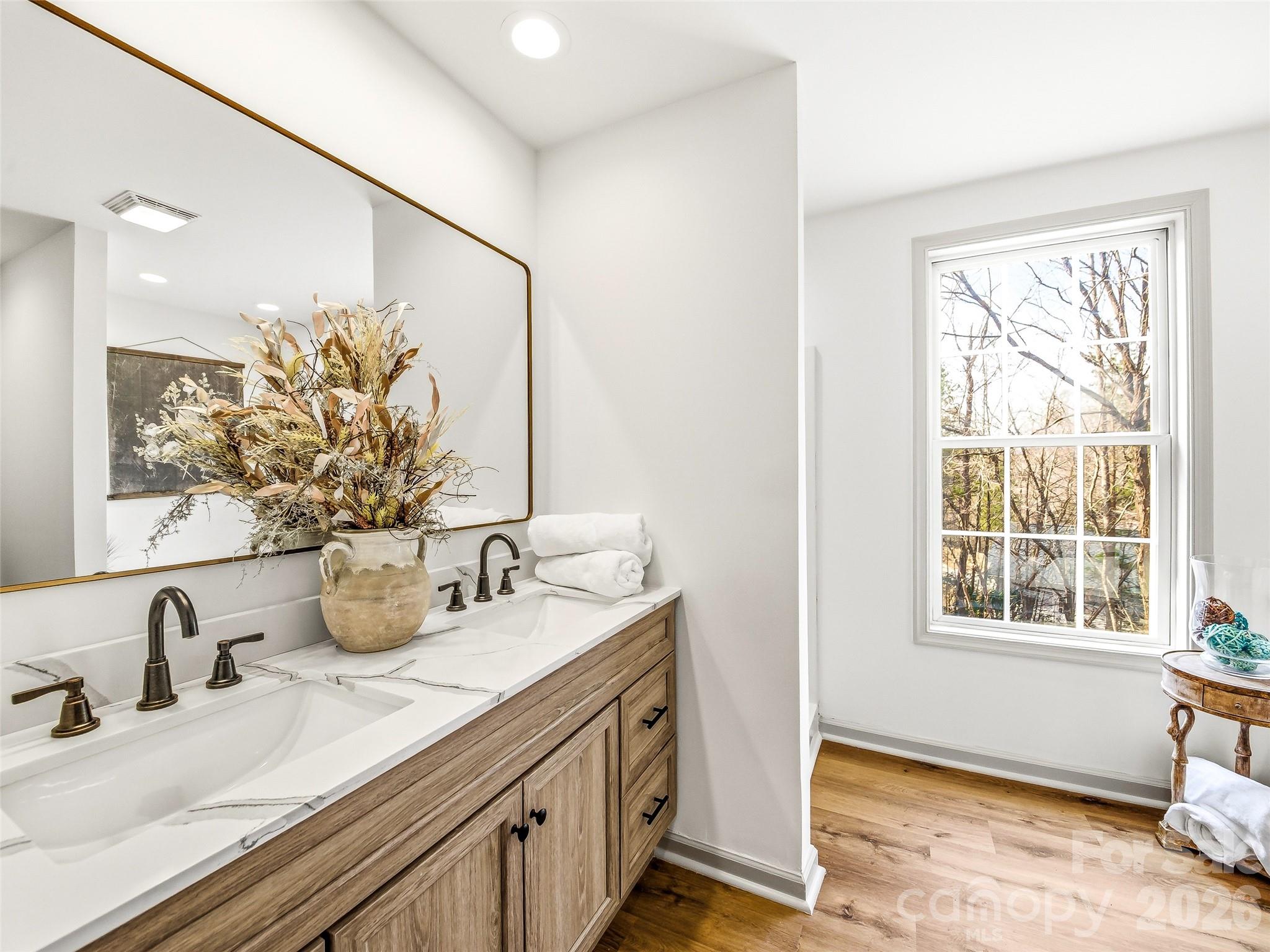 907 Gleason Street Arden, NC 28704 - Photo 25 of 41 a bathroom with a double vanity sink window and flower pot