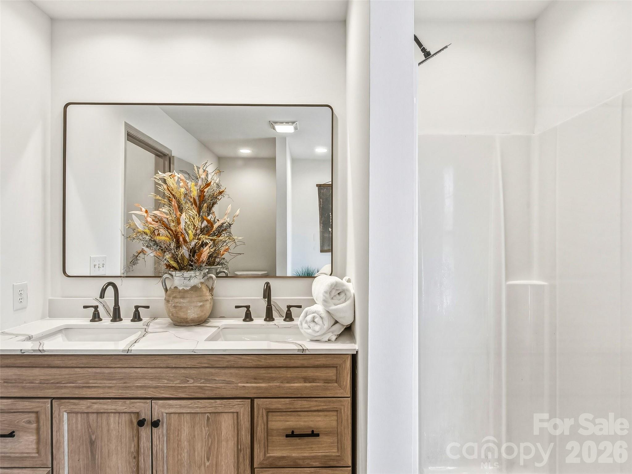907 Gleason Street Arden, NC 28704 - Photo 26 of 41 a bathroom with a granite countertop sink and a mirror