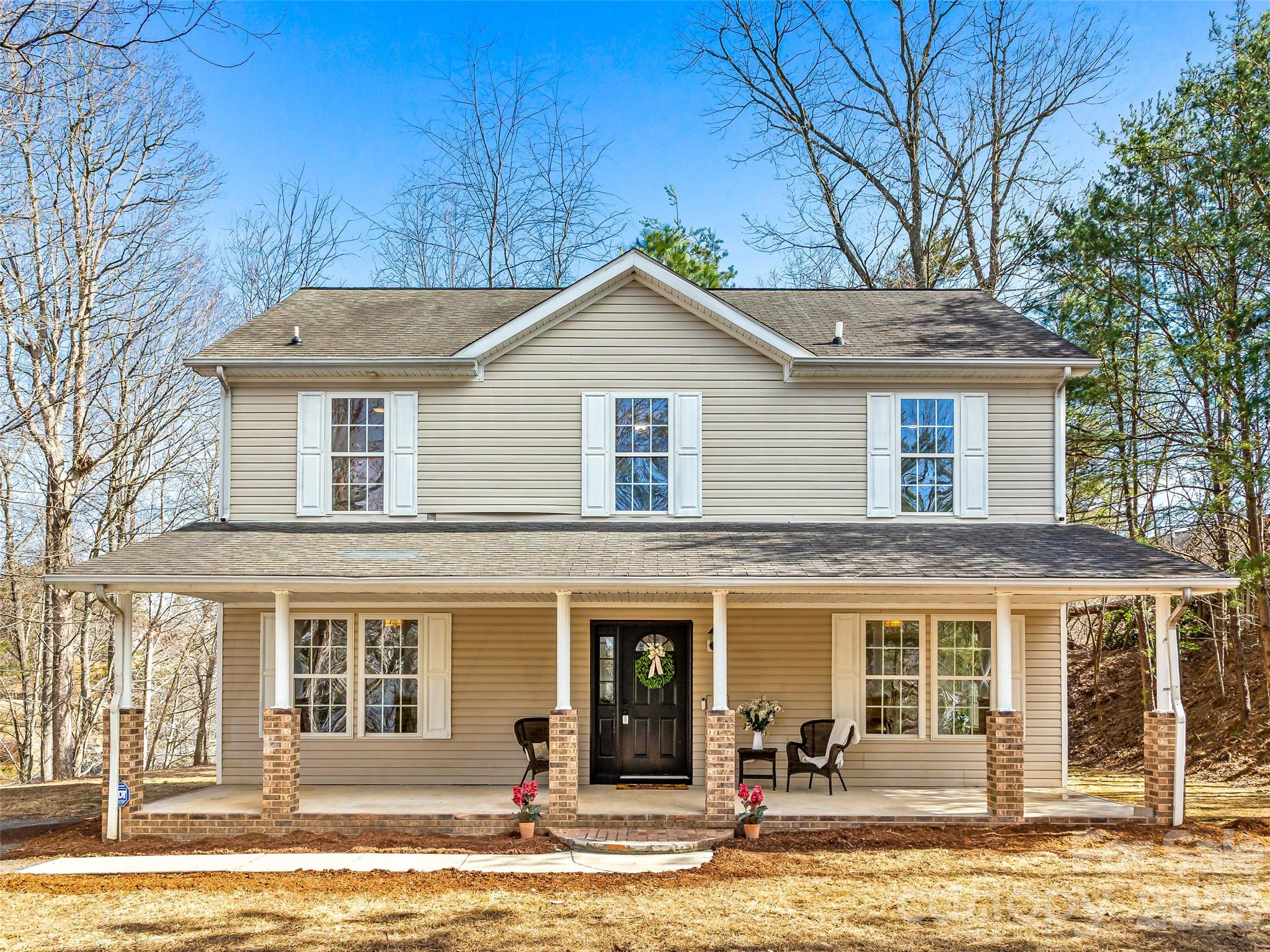 907 Gleason Street Arden, NC 28704 - Photo 38 of 41 a front view of a house with garden and trees