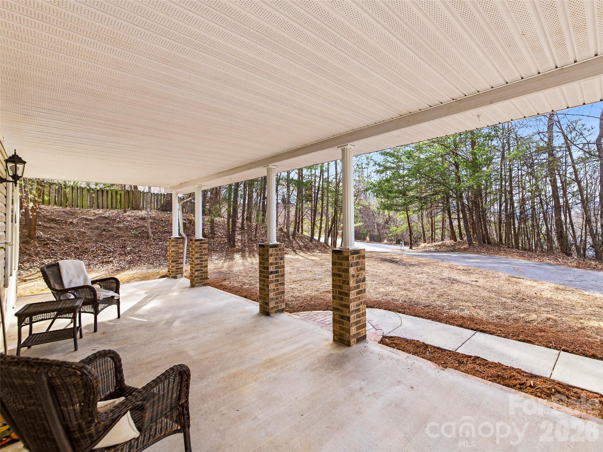 907 Gleason Street Arden, NC 28704 - Photo 4 of 41 a view of a patio with a table chairs and wooden fence
