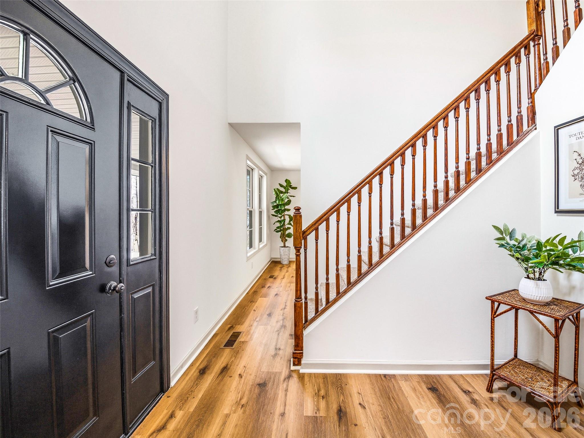 907 Gleason Street Arden, NC 28704 - Photo 5 of 41 a view of staircase with lots of frames on wall and a potted plant
