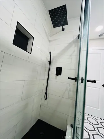 a bathroom with a shower and a mirror