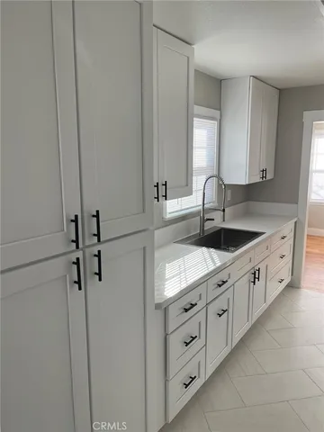 a kitchen with sink cabinets and window