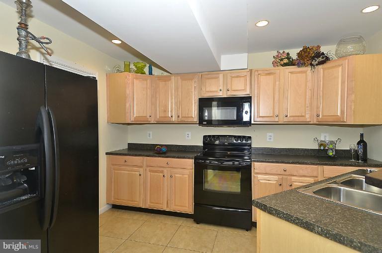 505 Great Falls Road Rockville, MD 20850 - Photo 13 of 30 a kitchen with a sink stove and microwave