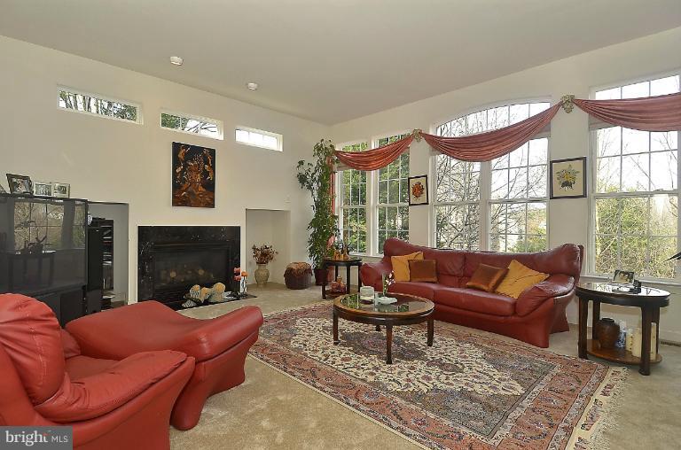 505 Great Falls Road Rockville, MD 20850 - Photo 18 of 30 a living room with furniture a fireplace and a large window