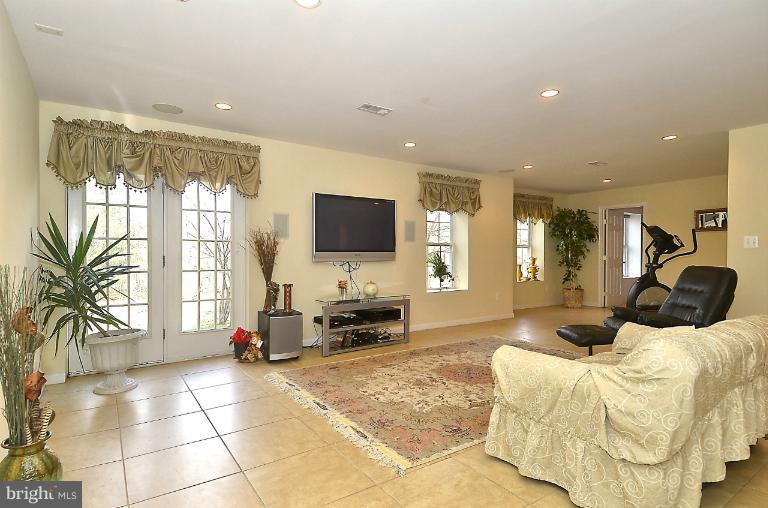 505 Great Falls Road Rockville, MD 20850 - Photo 23 of 30 a bedroom with furniture a flat screen tv and a large window