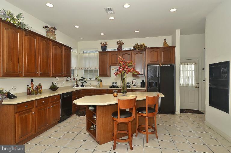 505 Great Falls Road Rockville, MD 20850 - Photo 29 of 30 a kitchen with stainless steel appliances kitchen island granite countertop a sink and cabinets