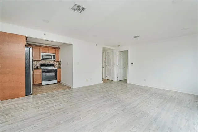 a view of a kitchen with a sink dishwasher and a refrigerator