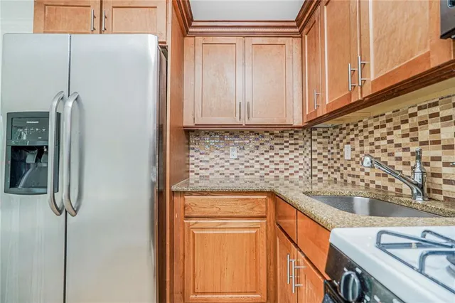 a kitchen with a refrigerator and a sink