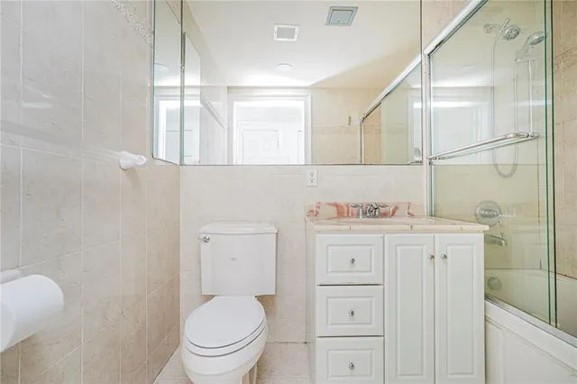 a bathroom with a toilet a sink and a mirror