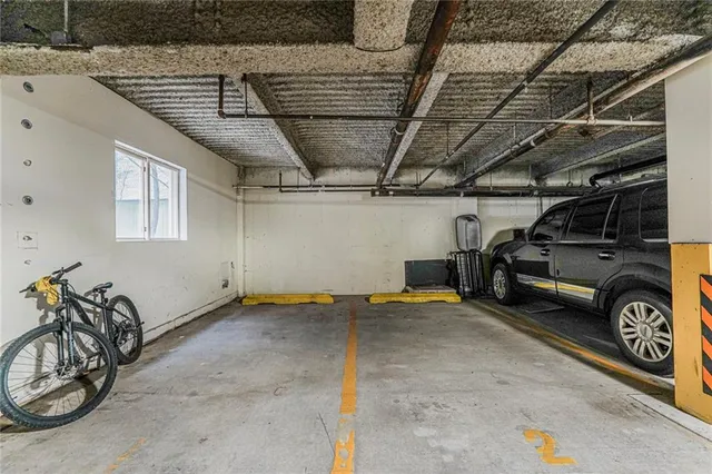 a view of parking garage with cars parked