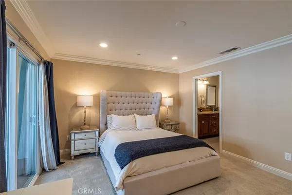 a bedroom with a bed and a mirror