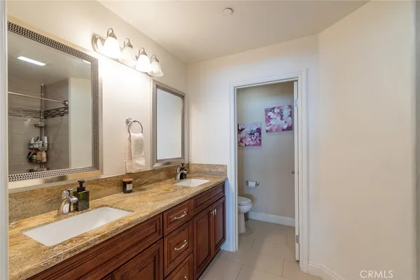 a bathroom with a double vanity sink mirror and double