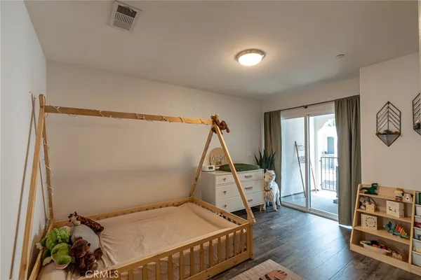 a bedroom with furniture and a wooden floor