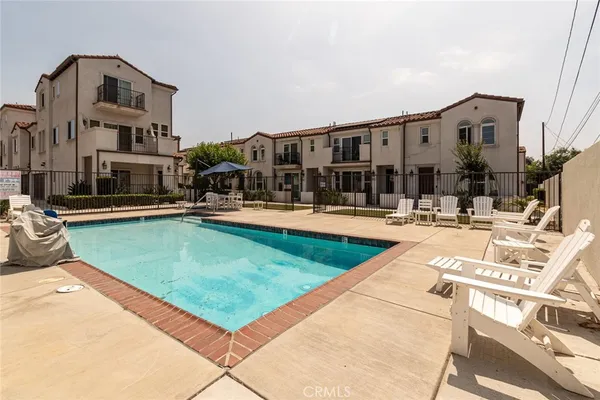 a swimming pool with outdoor seating and yard