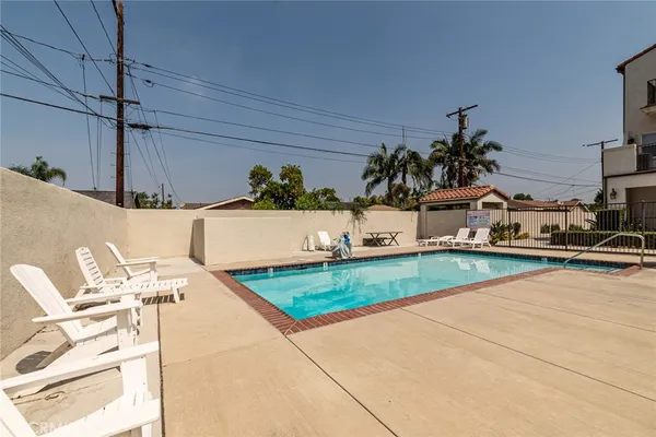 a view of swimming pool with outdoor seating and plants