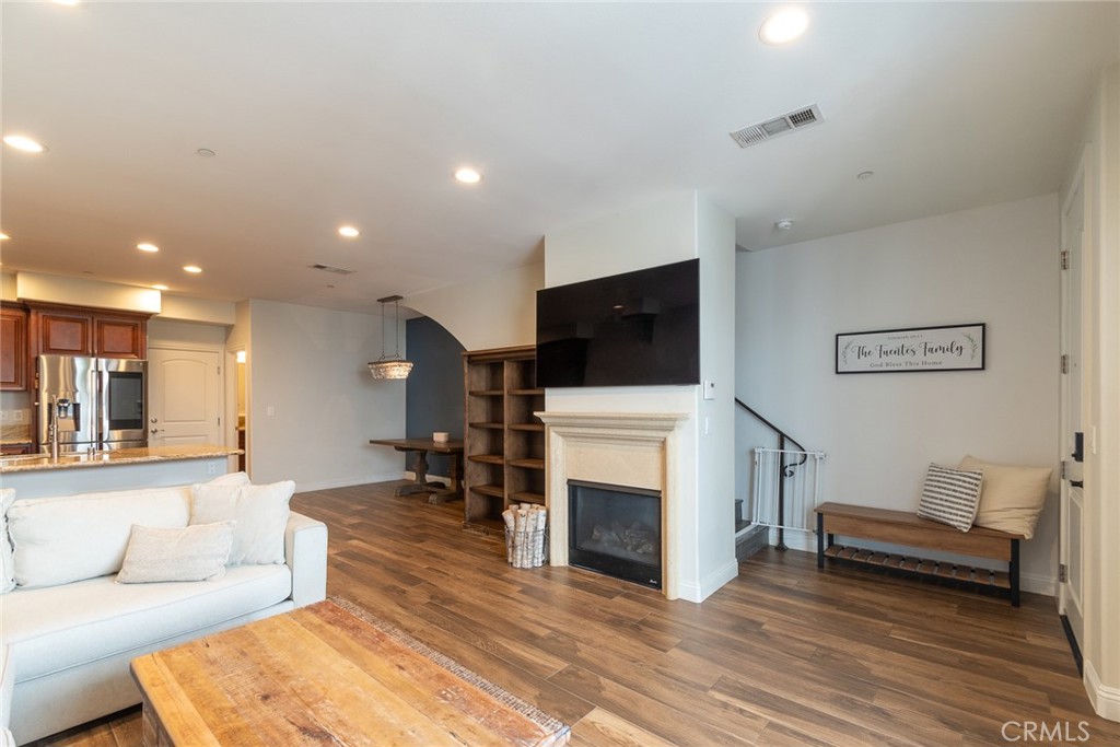 7019 Passons Boulevard Pico Rivera, CA 90660 - Photo 5 of 27 a living room with furniture a fireplace and a flat screen tv