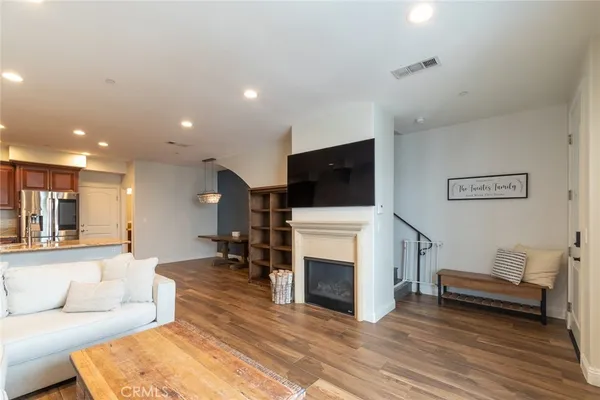 a living room with furniture a fireplace and a flat screen tv