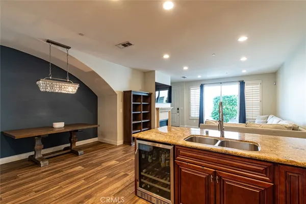 a kitchen with stainless steel appliances granite countertop a sink and a refrigerator