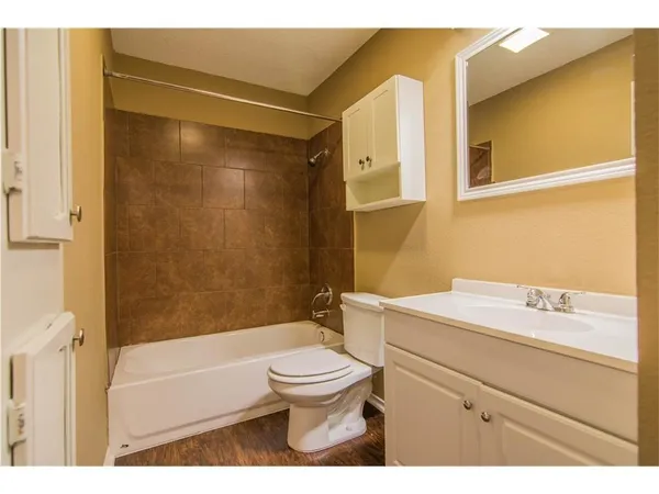 a bathroom with a sink toilet vanity and shower