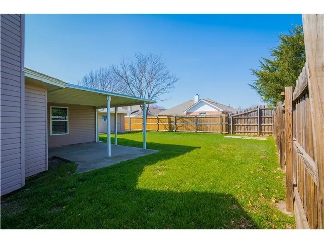 a view of a house with a back yard