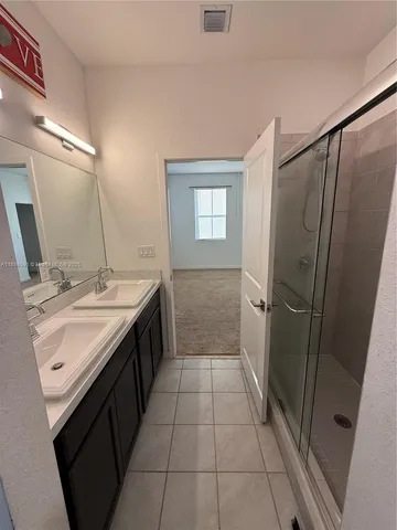 a bathroom with a sink a mirror and a shower
