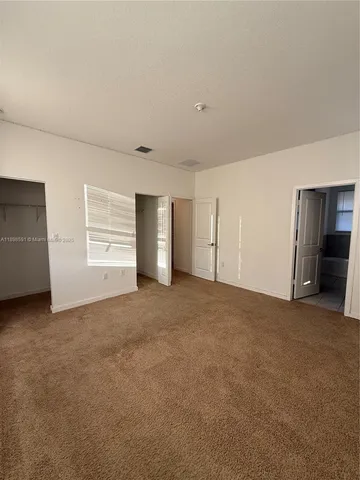 a view of an empty room with closet and closet