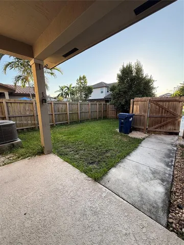 a view of a backyard with potted plants