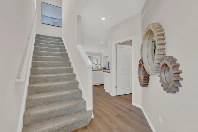 a view of entryway and hall with wooden floor