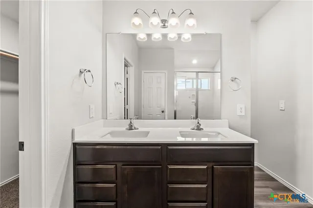 a bathroom with a sink vanity and a mirror