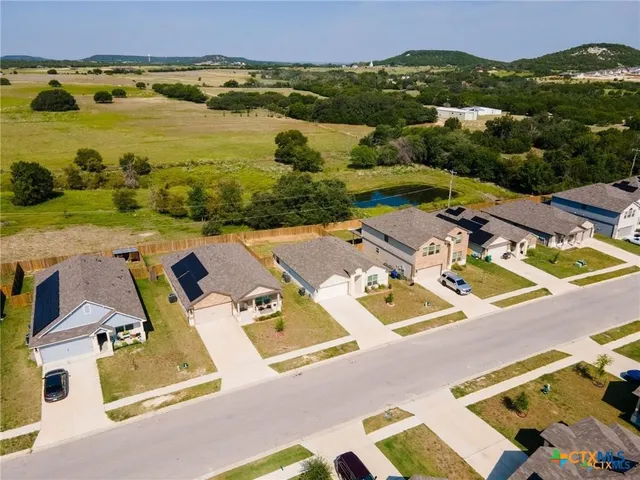 an aerial view of residential house with outdoor space and mountain view