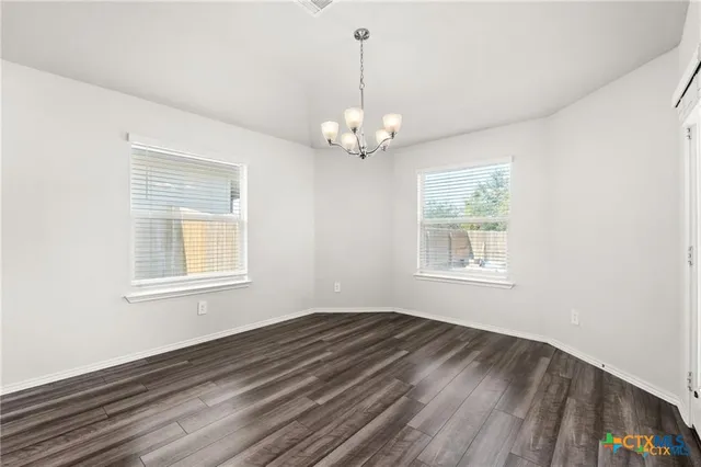 a view of wooden floor and windows in a room