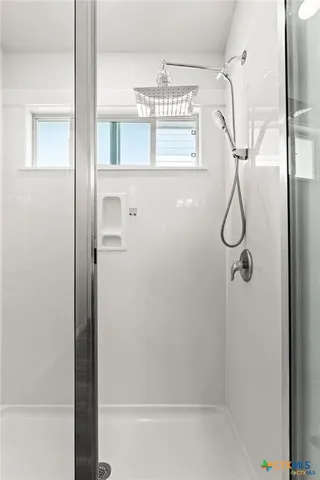 a bathroom with a glass shower door